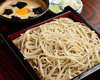 Chilled buckwheat soba noodles served on a bamboo strainer with grated yam dipping sauce