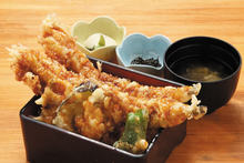 Tempura served over rice in a lacquered box