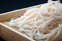 Wheat noodles served on a bamboo strainer