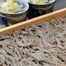 Buckwheat noodles served on a bamboo strainer