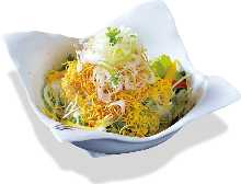 Salad topped with crispy fried noodles