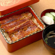 Premium eel served over rice in a lacquered box