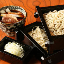 Buckwheat noodles served on a bamboo strainer with duck