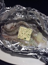 Grilled squid tentacles with garlic butter in foil