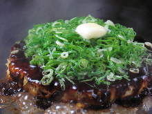 Pork okonomiyaki topped with grilled spring onion and butter
