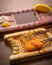 Deep-fried and skewered herring eggs on kelp