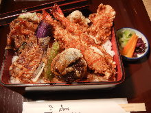 Tempura served over rice in a lacquered box