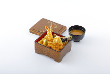 Tempura served over rice in a lacquered box