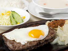Hamburg steak topped with an egg sunny-side up