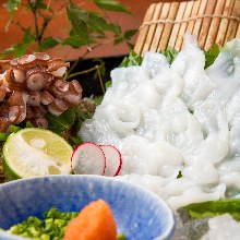 Live octopus thinly sliced sashimi