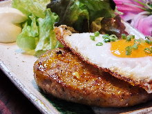 Hamburg steak topped with an egg sunny-side up