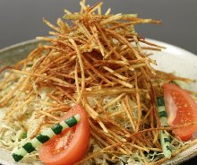 Salad topped with crispy fried noodles