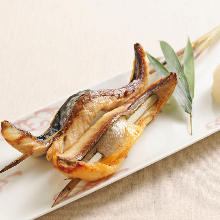 Grilled dried in ashes mackerel skewered