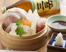 Vegetables and pork steamed in a bamboo steamer