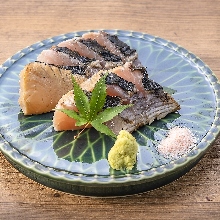 Seasonal fish grilled on straw mats