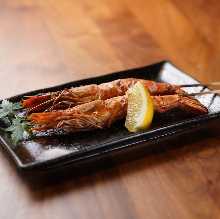 Grilled skewers of headed shrimp