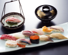 Assorted nigiri sushi (12 kinds) with a seasonal dish served in a bowl
