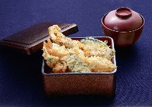 Tempura served over rice in a lacquered box