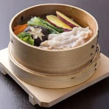 Vegetables and pork steamed in a bamboo steamer