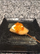 Fried salmon skewer topped with salmon roe