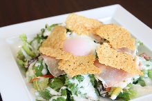 Caesar salad with soft-boiled egg and prosciutto