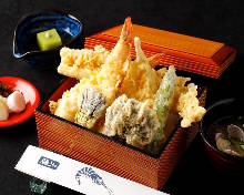 Tempura served over rice in a lacquered box