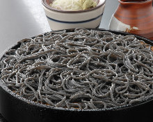 Buckwheat noodles served on a bamboo strainer