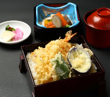 Tempura served over rice in a lacquered box