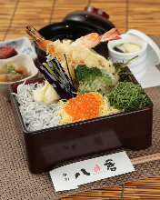 Tempura served over rice in a lacquered box