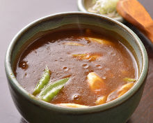 Buckwheat noodles with curry sauce and scallions