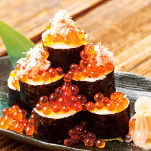 Sushi roll topped with crab and salmon roe