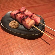 Grilled wiener sausage and bacon skewer