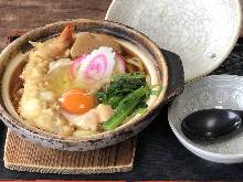 Wheat noodles boiled in a ceramic pot