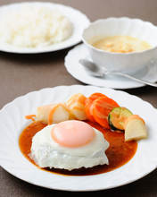 Hamburg steak topped with an egg sunny-side up