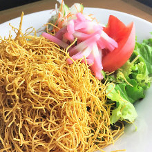 Salad topped with crispy fried noodles