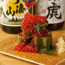 Overflowing iIkura (salmon roe) sushi