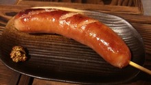 Grilled wiener sausage and bacon skewer