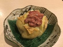 Potatoes, topped with butter or salt-fermented squid