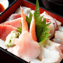 Seafood served over rice in a lacquered box