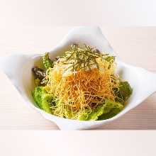 Salad topped with crispy fried noodles
