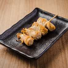 Grilled meat-wrapped enoki mushroom skewer