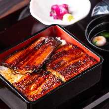 Premium eel served over rice in a lacquered box