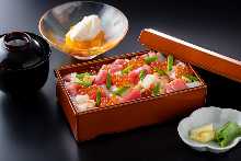 Seafood bara chirashi bento box, small side dish, pickles, miso soup