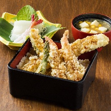 Tempura served over rice in a lacquered box meal set