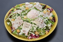 Caesar salad with soft-boiled egg and prosciutto