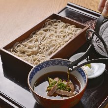 Buckwheat noodles served on a bamboo strainer with duck