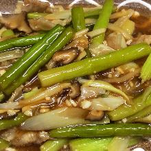 Stir-fried pork and garlic scapes