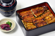 Premium eel served over rice in a lacquered box