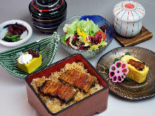 Mini eel served over rice in a lacquered box