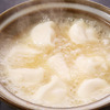 Boiled gyoza dumpling with shamo dashi soup